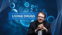 Dr. Michel Sadelain with blue 3D renderings of cells in the background. Text overlay: ‘Dr. Michel Sadelain, MD, PhD – Living Drugs: The Man Who Changed the Paradigm.